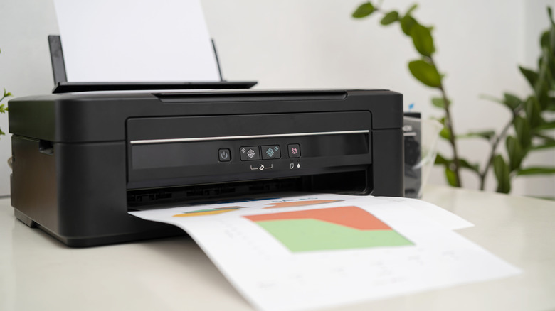 Home printer on a desk with a project in progress.
