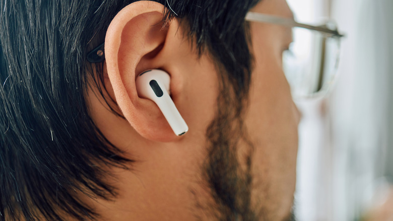 Man with glasses wearing Apple AirPods