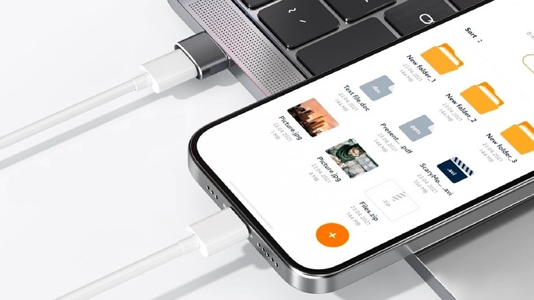 USB-C adapter plugged into computer and connected to phone with cable.