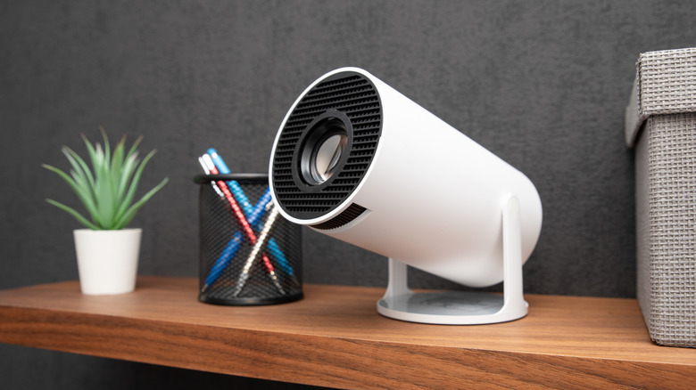 A wireless white projector on a shelf