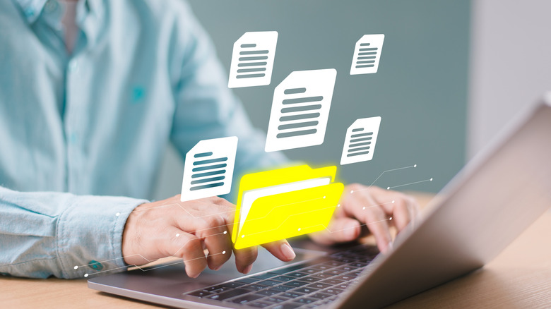 File visualization cartoon icons floating above laptop