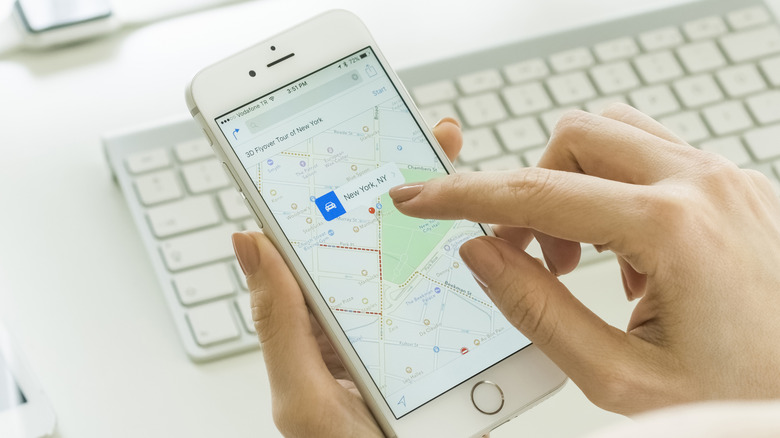 A person using Apple Maps on an iPhone.
