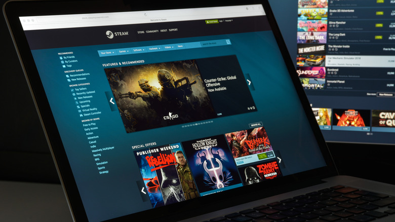 A laptop computer displaying the Steam digital distribution service, there is also a monitor in the background that can be seen showing the service