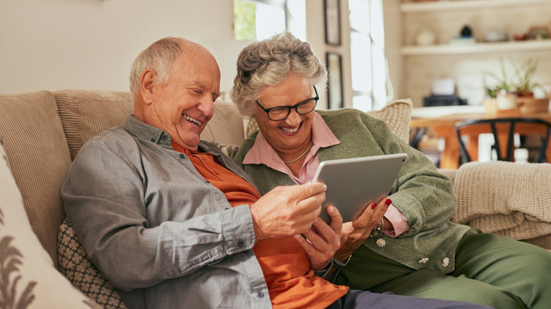 grandparents viewing camera feed on tablet