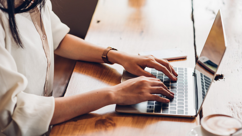 person using laptop in bright room