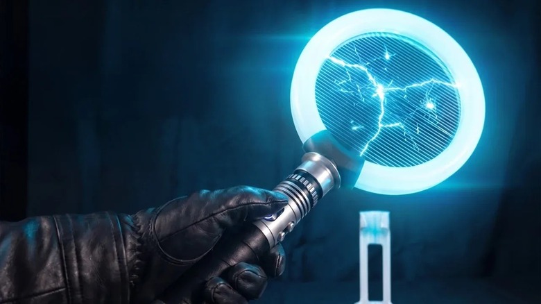 Gloved hand holding the Bug Saber with blue glow.