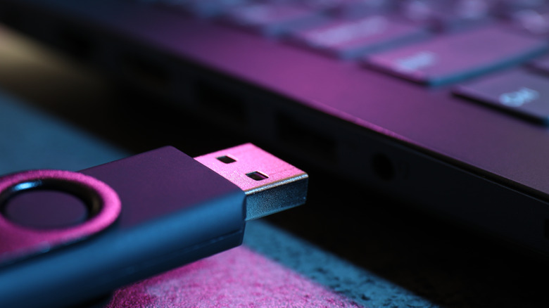 Usb flash drive being plugged into a laptop