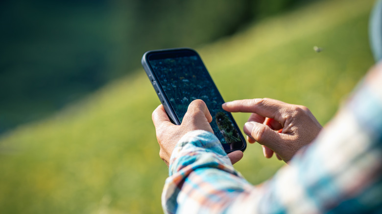 Person adjusting settings on phone