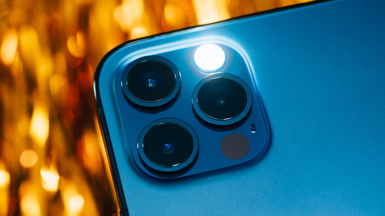 iPhone 12 camera lenses with flash/flashlight illuminated
