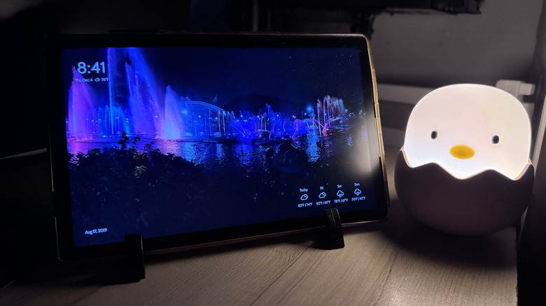 Old Android tablet turned into digital photo frame, with a night light next to it