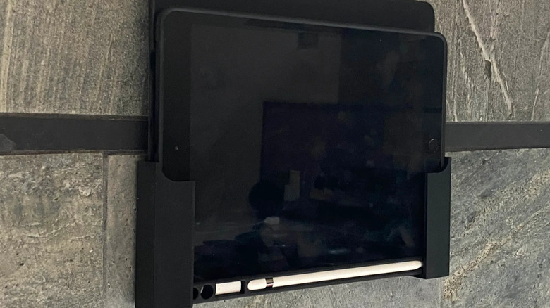An iPad mounted to the wall with a 3D printed mount