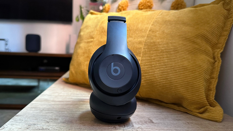 Beats Studio Pro on a bench with some cushions behind the headphones