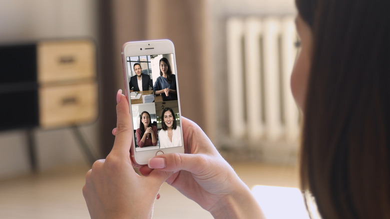 A person using FaceTime group call on an iPhone