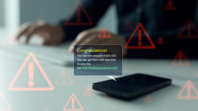 Concept for scam text messages, where a virtual text bubble appears over a smartphone laying on the table.