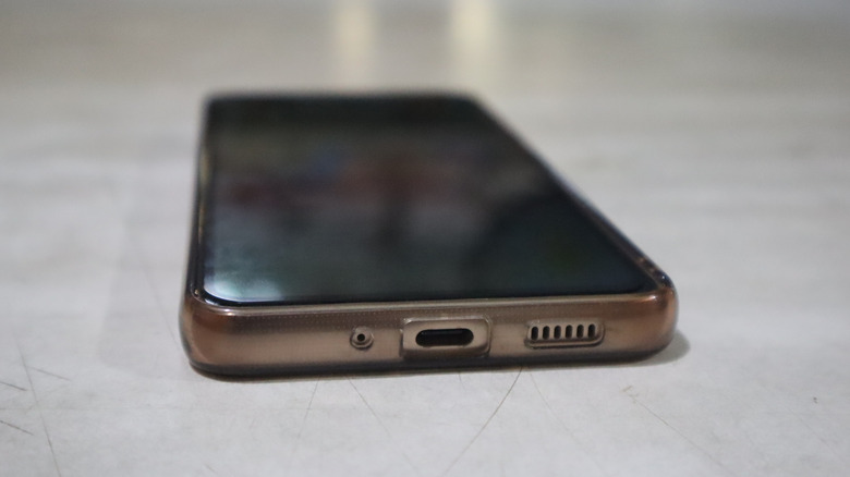 A Samsung Galaxy S21 laying on a table, with its USB-C port facing the camera.