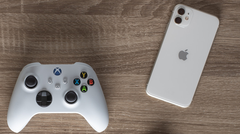 An iPhone and Xbox Wireless Controller