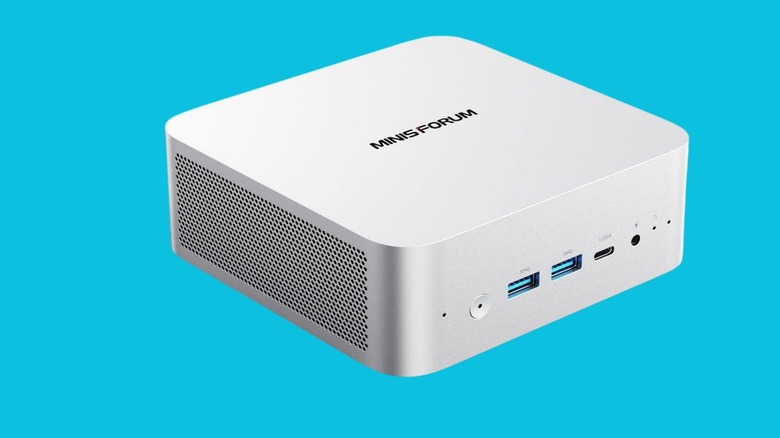 A MINISFORUM mini PC in silver on a blue background.