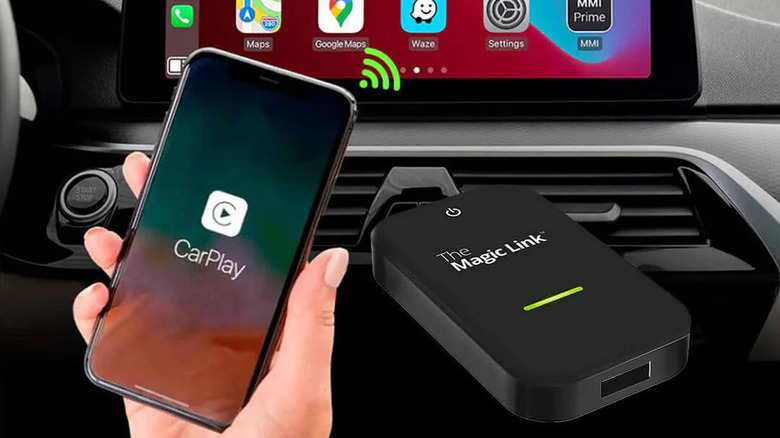 Person holding iPhone wirelessly connected to CarPlay via Magic Link adapter