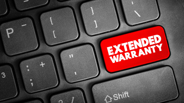 Laptop keyboard with extended warranty text on keycap