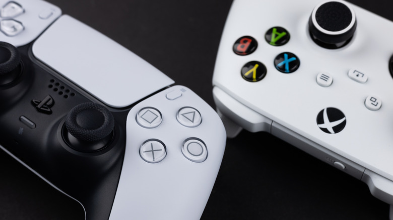 A PlayStation 5 controller and Xbox Series X controller facing against each other
