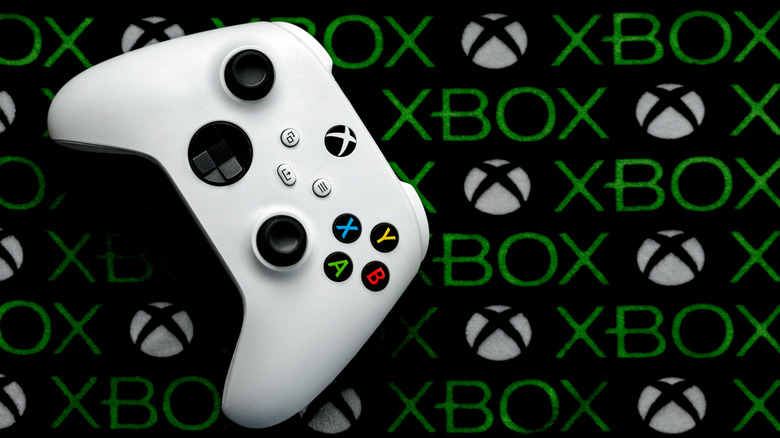 An Xbox controller on a background filled with the Xbox logo repeating