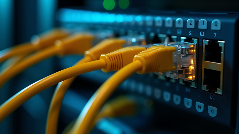 Multiple yellow Ethernet cables connected to a server