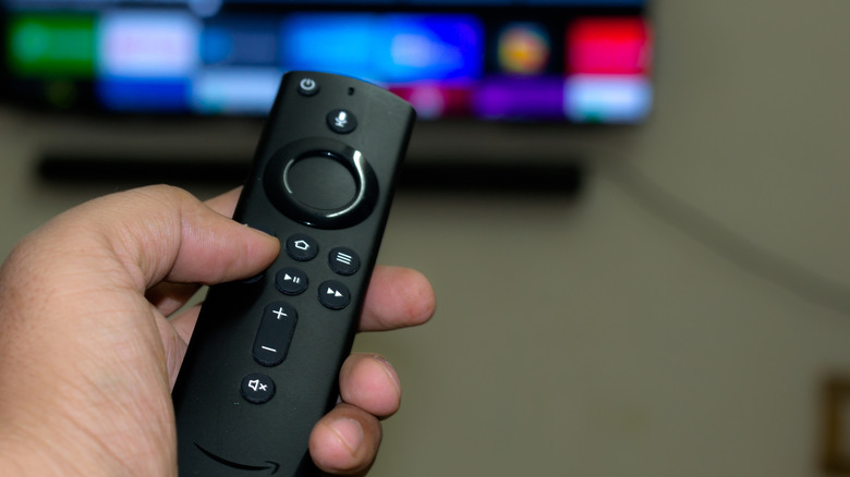 Hand holding an Amazon Fire TV remote