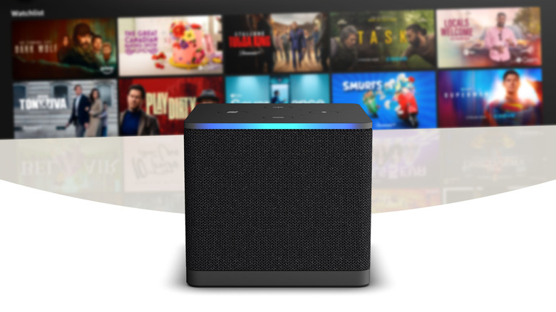 An Amazon Fire TV Cube in front of a blurred TV