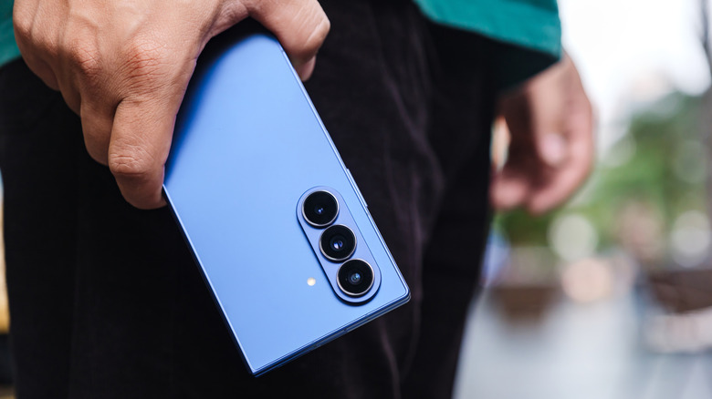 Man holding phone showing Android camera