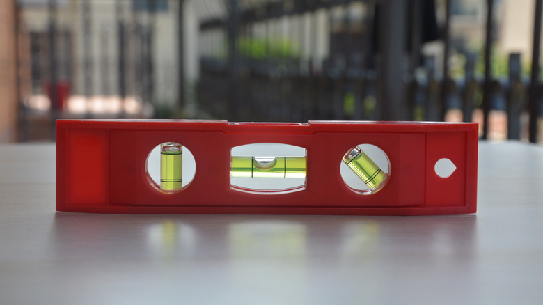 A red plastic bubble level on a desk