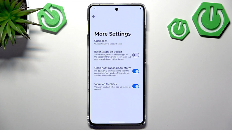 A Motorola phone showing an Android setting to open notifications in a freeform window