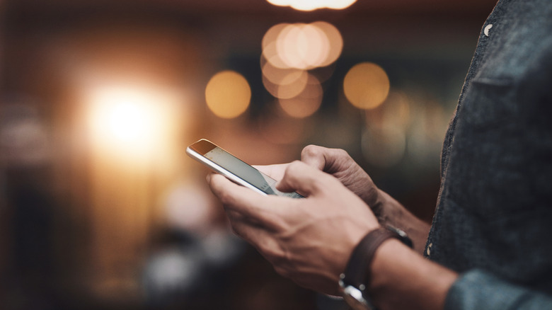 Person using a mobile keyboard on a smartphone.