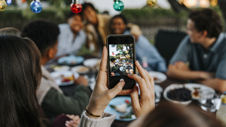 A person taking a photo with a smartphone