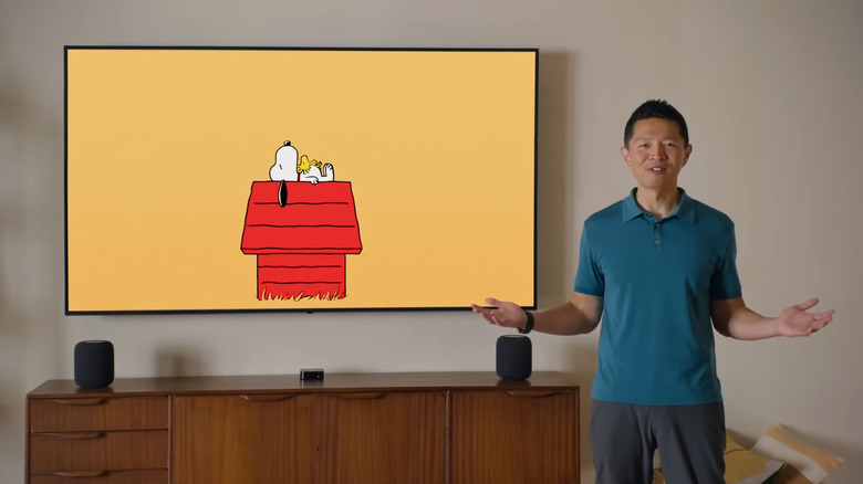 The Snoopy screen saver shown on an Apple TV device, streaming to a TV mounted on the wall.