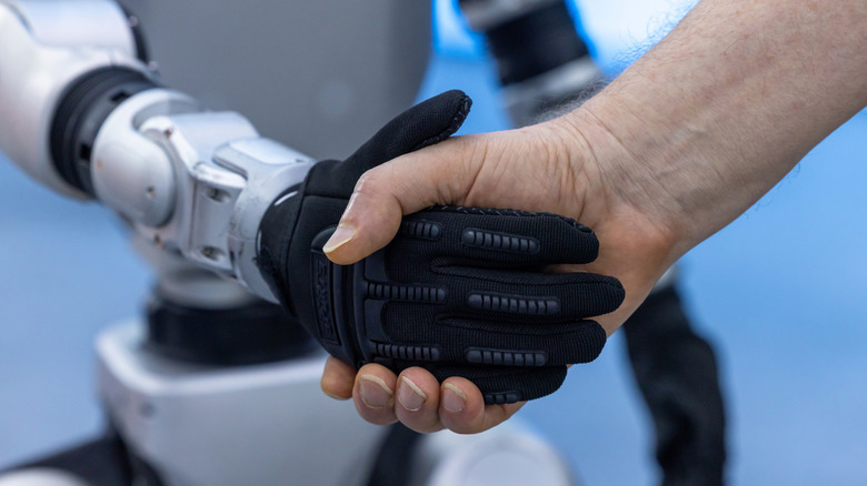 Human and robot shaking hands