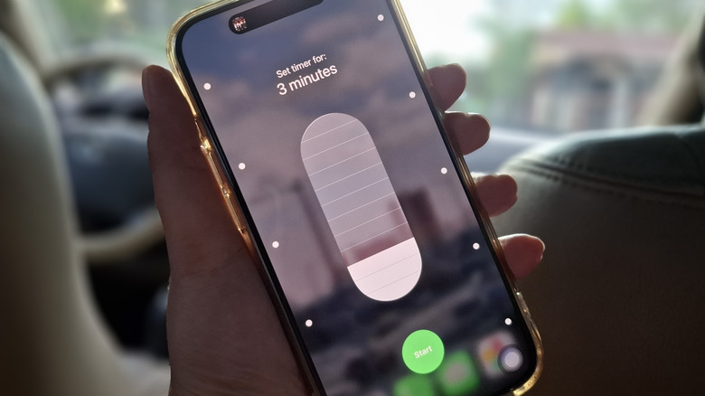 Hand holding iPhone with timer from Control Center