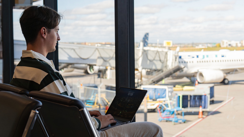Man using laptop at airport