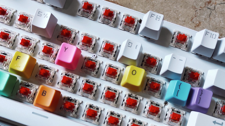 keyboard taken apart, showing switches underneath, waiting to be worked on