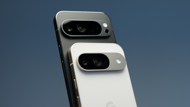 Two Google Pixel phones, with a white one in front of a black one, in front of a dark blue background