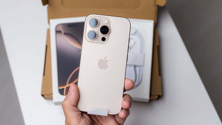 The iPhone 16 Pro being unboxed with the phone's back design shown.