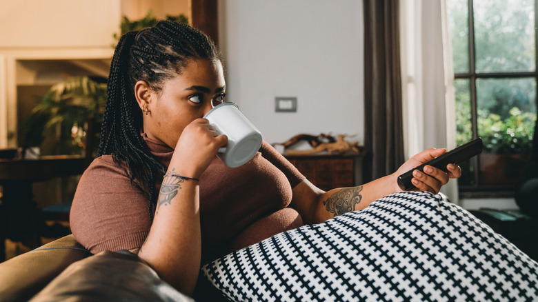 person watching tv on couch