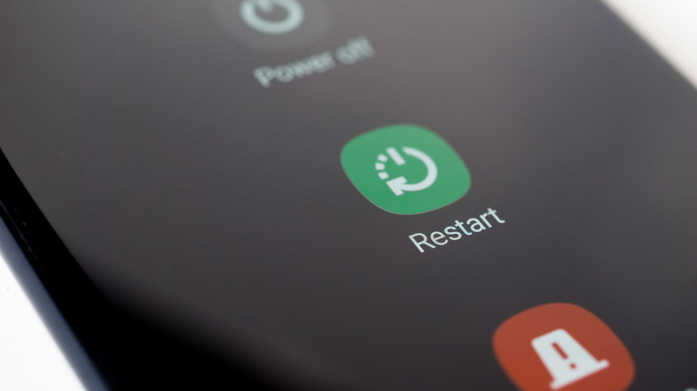 A close-up of the restart button on an Android smartphone