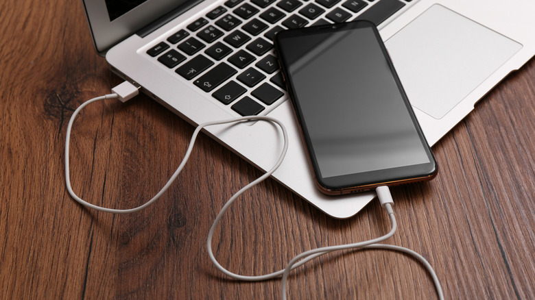 Smartphone plugged into a laptop