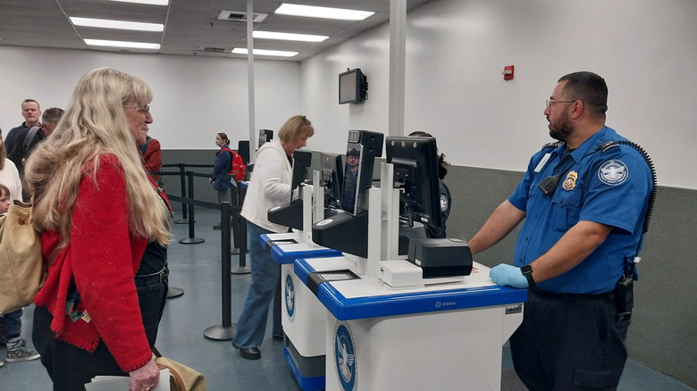 people check in with TSA at an airport as they prepare to travel