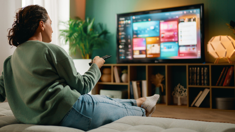 A woman watching TV in a modern living room.