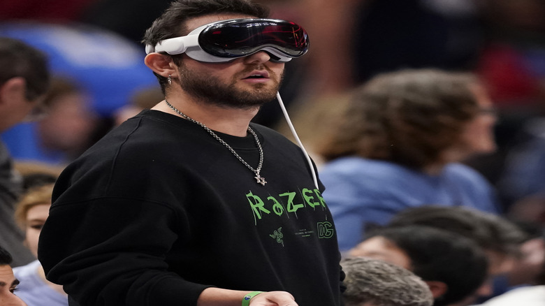 A person wearing a virtual screen TV headset out in public.