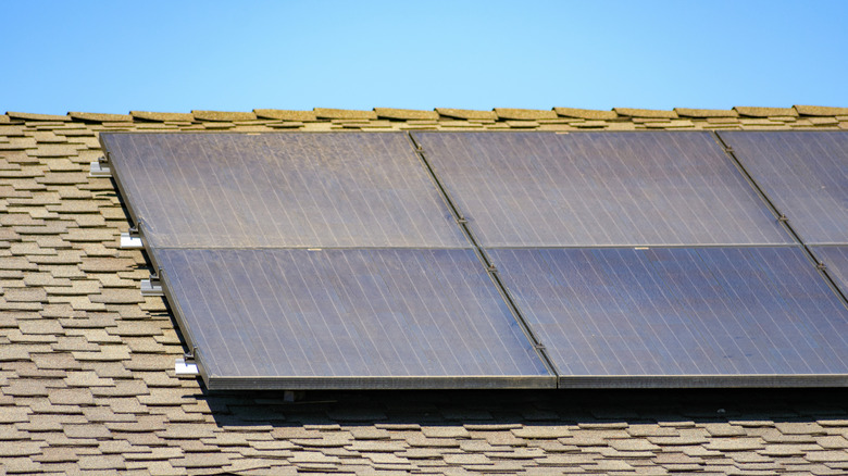 Dirty solar panels mounted on a residential roof