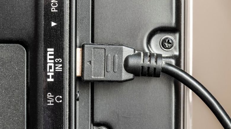 HDMI cable plugged into an HDMI port on the rear of a television