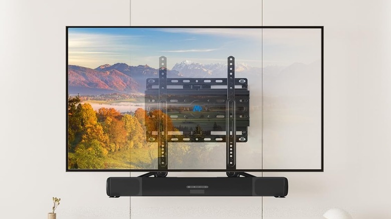 A soundbar mounted to a TV wall mount.