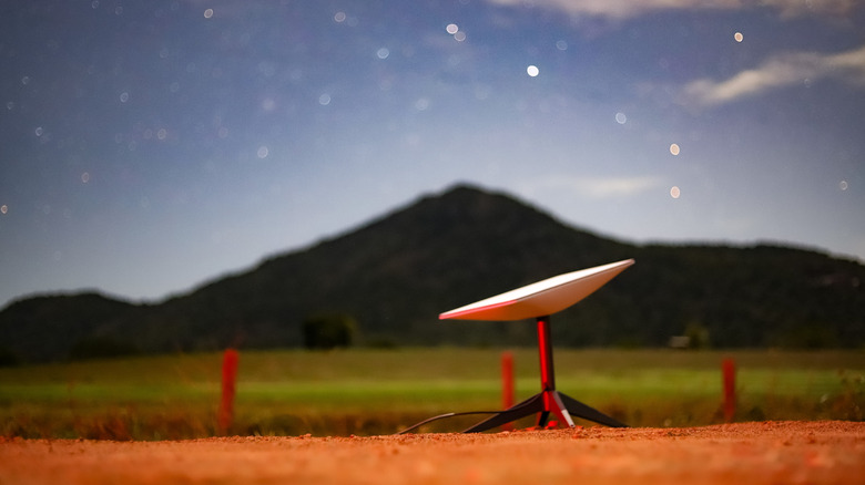 Starlink dish or user terminal deployed with the night sky visible